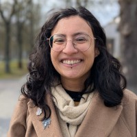 A latina-looking woman wearing glasses and smiling - that's me!